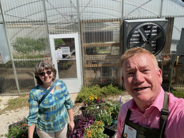 Richard and Shirley picking out plants in the greenhouse.