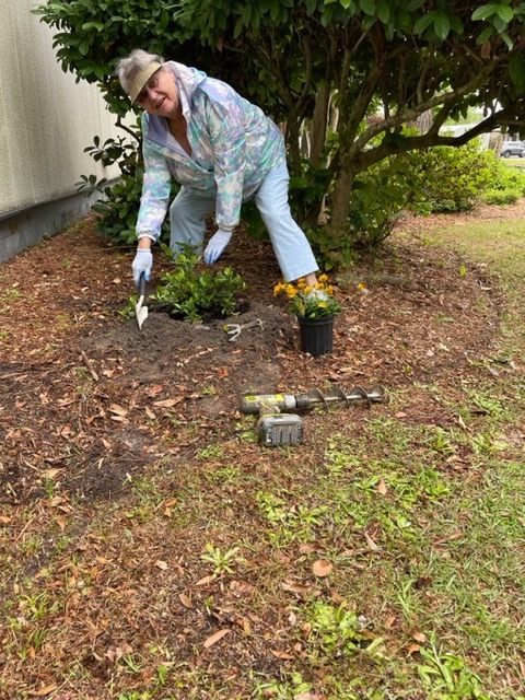 Lainie happily at work planting.